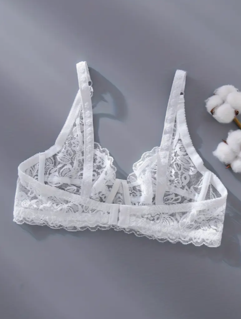 White lace bra on a gray background with cotton plant in the corner by The Seventh Muse