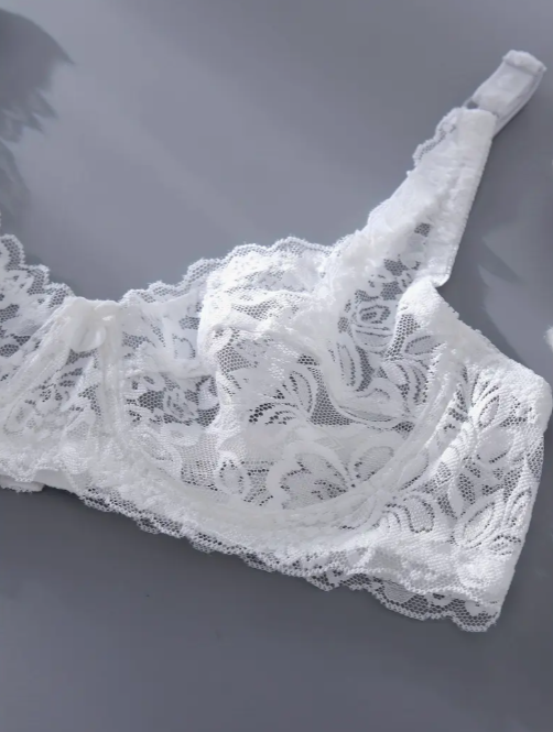 White lace lingerie on a gray background by The Seventh Muse