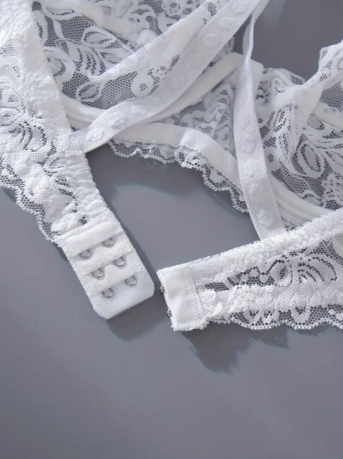 Close-up of white lace trim on a gray background by The Seventh Muse