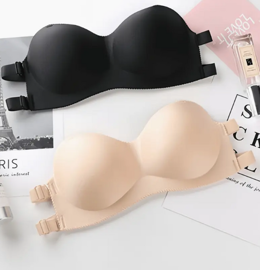 Model wearing a smooth, black and beige contour strapless bra with a sweetheart neckline, suitable for fitted and off-shoulder dresses