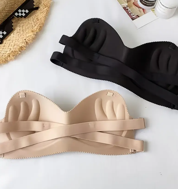 Model wearing a smooth, black and beige contour strapless bra with a sweetheart neckline, suitable for fitted and off-shoulder dresses