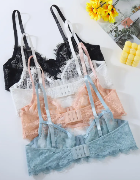 Four unwire push up lace bras by The Seventh Muse in black, blue, white and peach on a white background