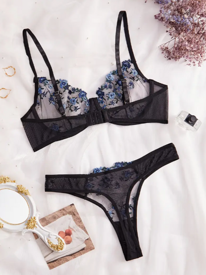 A black lace lingerie set with semi-sheer blue floral embroidery, consisting of a bra and panty