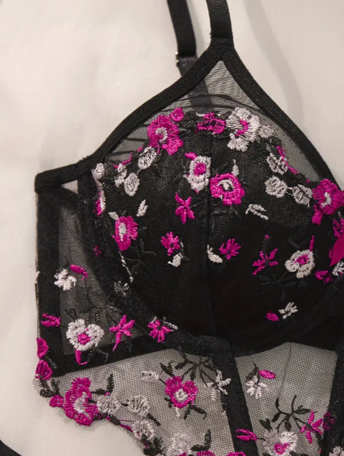 Black sheer floral embroidered lingerie set with pink and white lace detailing, featuring balconette bra and matching thong from The Seventh Muse – premium women’s intimate wear for a luxurious, elegant look