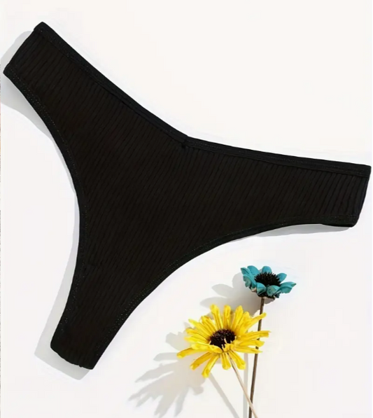 Black ribbed underwear on a white background with flowers.