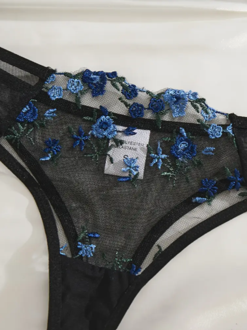 Black semi-sheer embroidered lace lingerie set featuring a soft lace bra with floral detailing and a matching lace panties