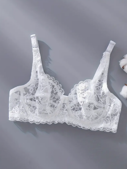 White lace bra on a gray background by The Seventh Muse