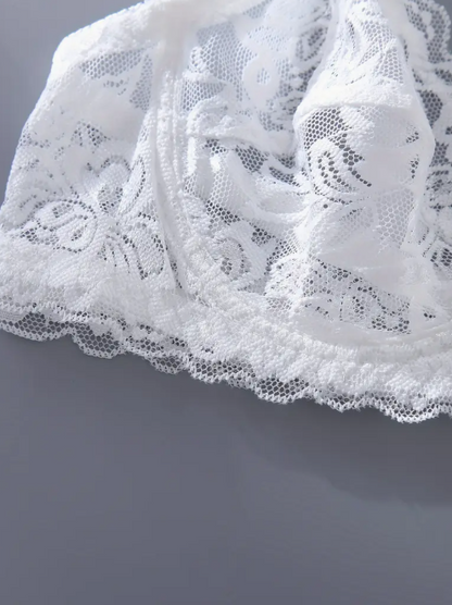 Close-up of white lace fabric on a gray background by The Seventh Muse