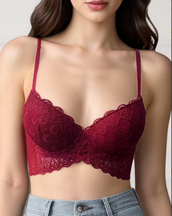 Red lace bra worn by a model against a neutral background