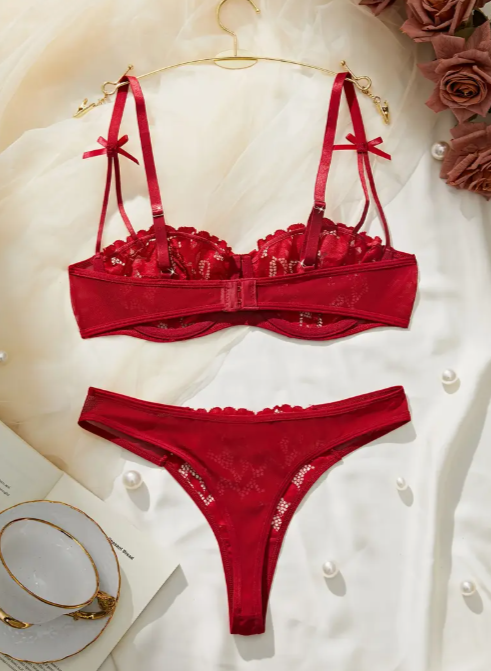 Red lace bra and thong set from The Seventh Muse with small bow details on the straps, and full floral embroidery.
