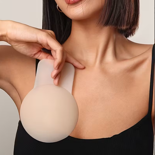 Woman wearing a silicone breast lift ups against a neutral background