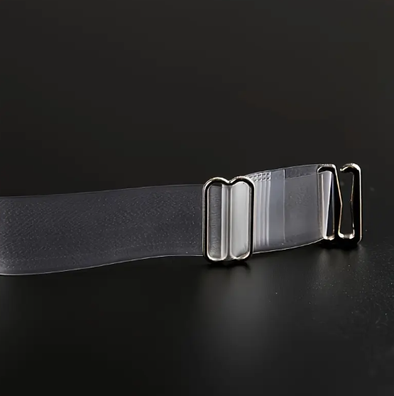 Close-up of two adjustable, transparent clear bra straps with silver-toned metal clasps and adjusters on a dark background.
