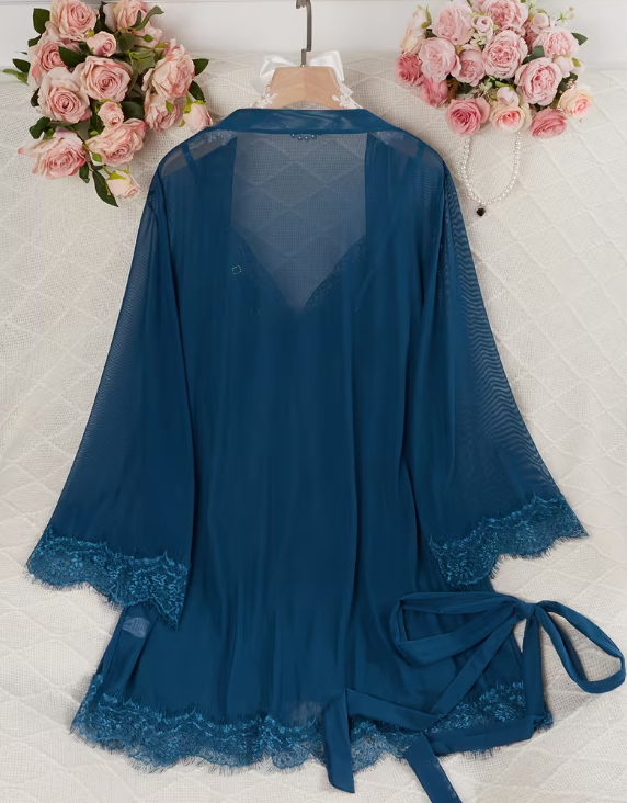 Blue lace robe on a white surface with pink flowers in the background