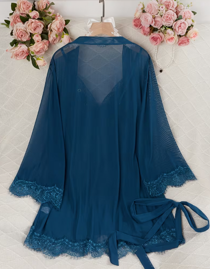 Blue lace robe on a white surface with pink flowers in the background