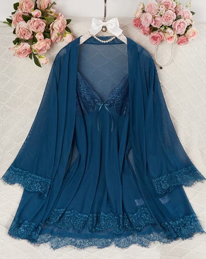 Blue lace dress with matching shawl on a hanger against a floral background
